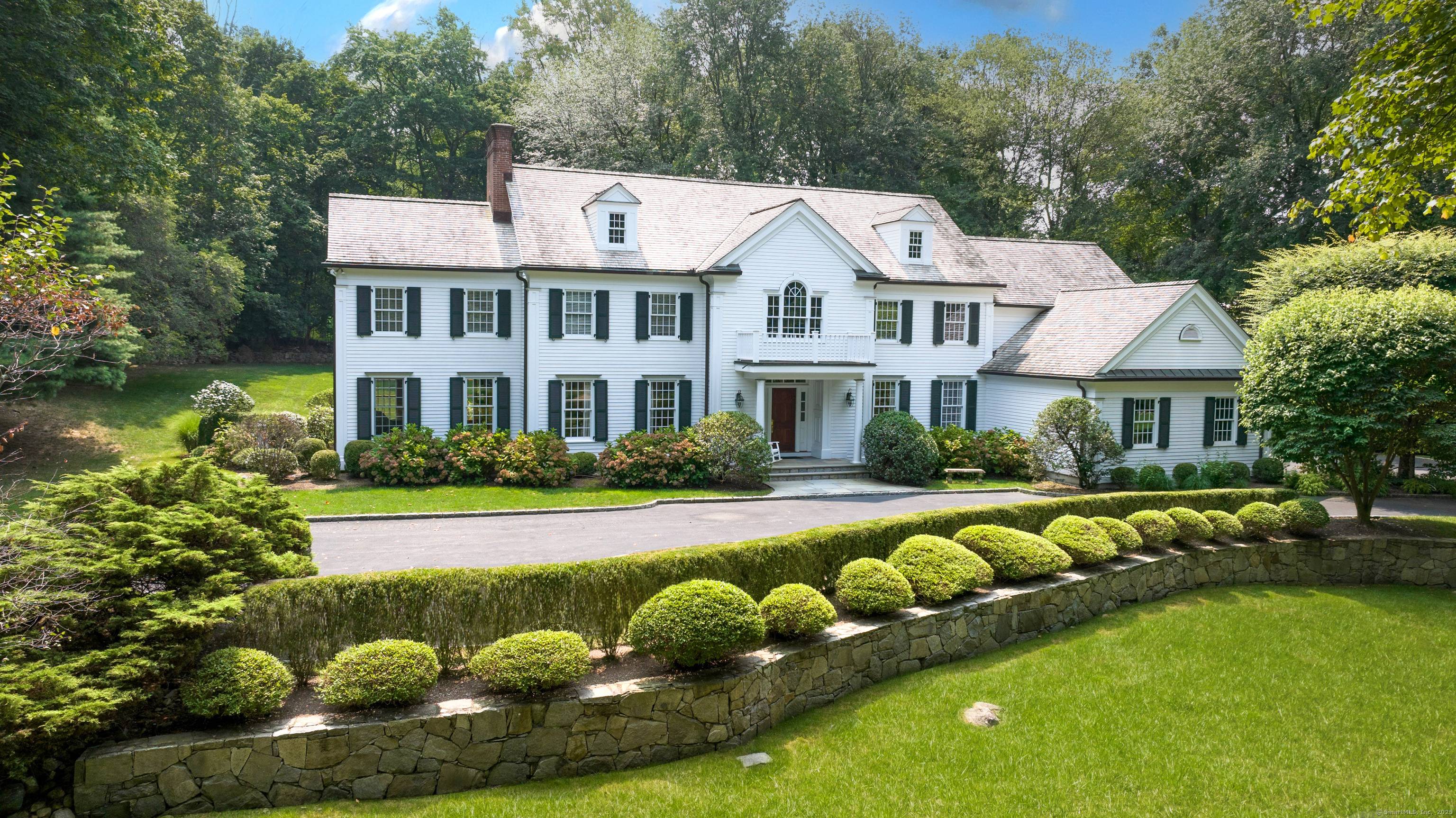 A stately approach evokes the grandeur of this elegant five bedroom Colonial.