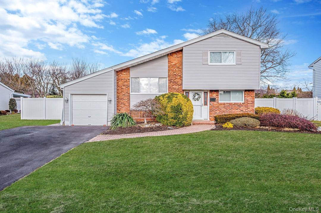 Welcome to this updated multi level home ideally situated on a quiet, tree lined street in Commack.