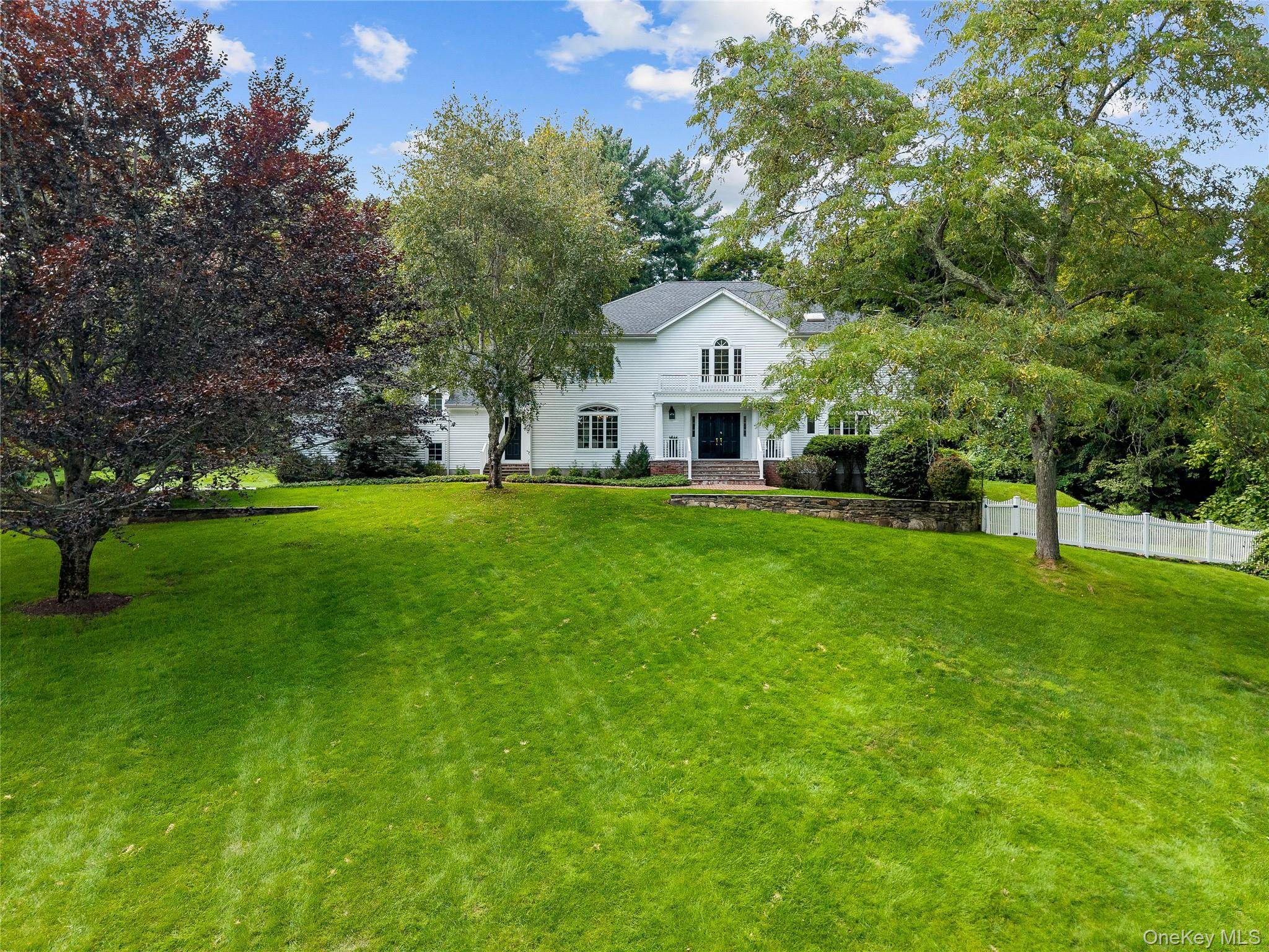 Spacious, immaculate white center hall Colonial perched beautifully on 2 sweeping landscaped acres with a beautiful heated gunite saltwater pool.