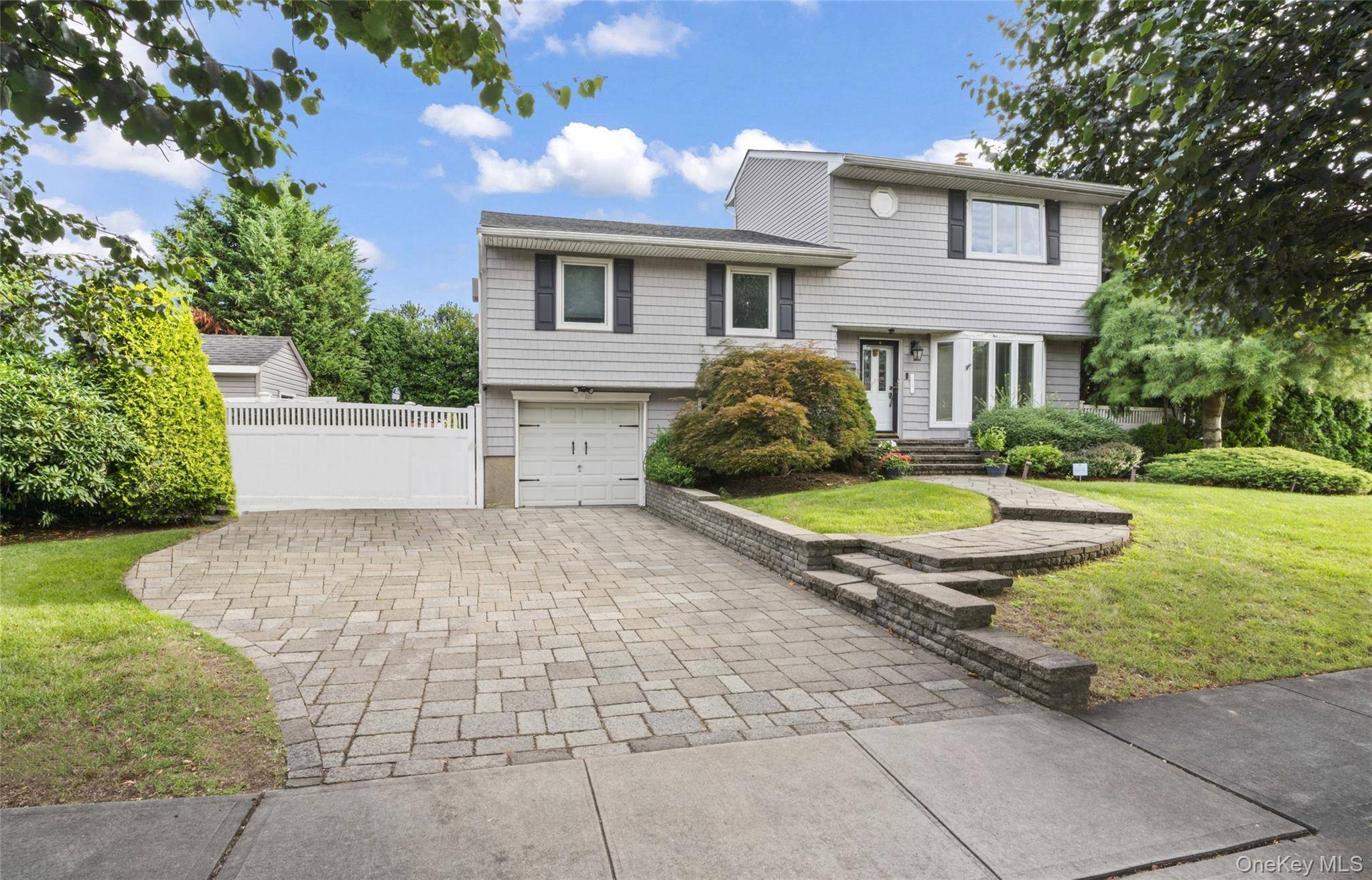 This fully updated 4 bedroom, 3 bath split level surrounded by 12 foot green giant trees combines modern luxury with privacy.