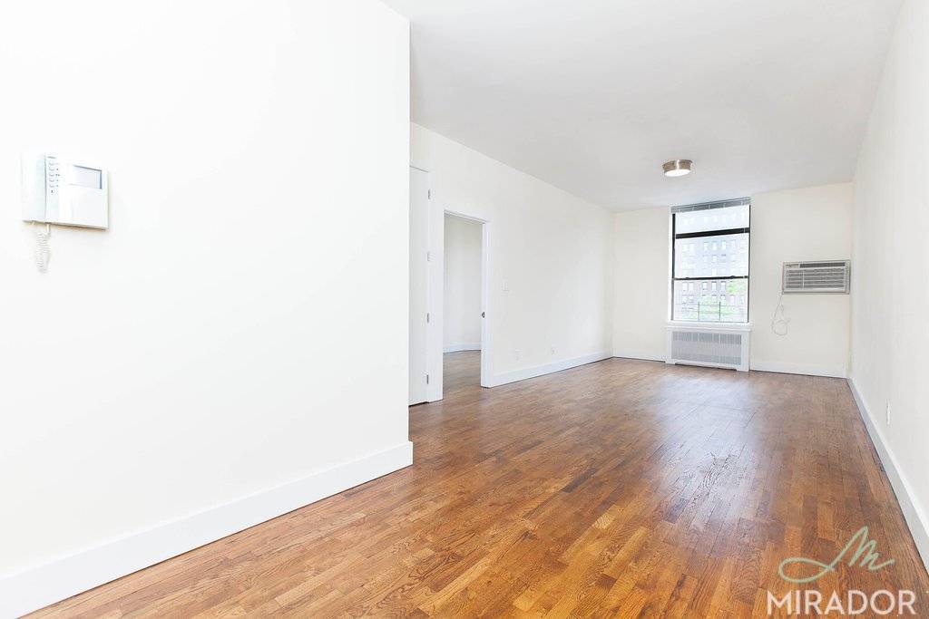 Huge, sunny, one bedroom with oversized windows, hardwood floors, renovated kitchen with stainless steel appliances, including a dishwasher.