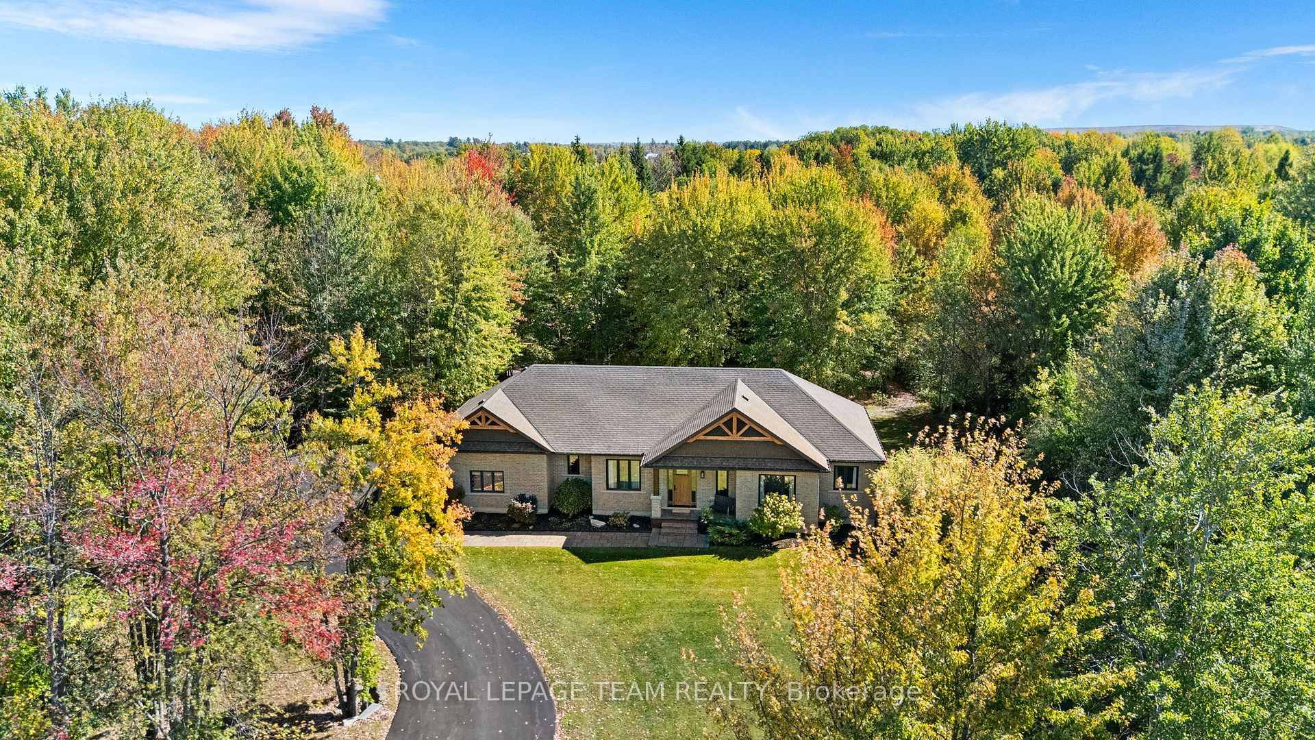 This custom built bungalow is nestled on a private 4 acres with a park like setting featuring numerous species of newly planted vegetation.