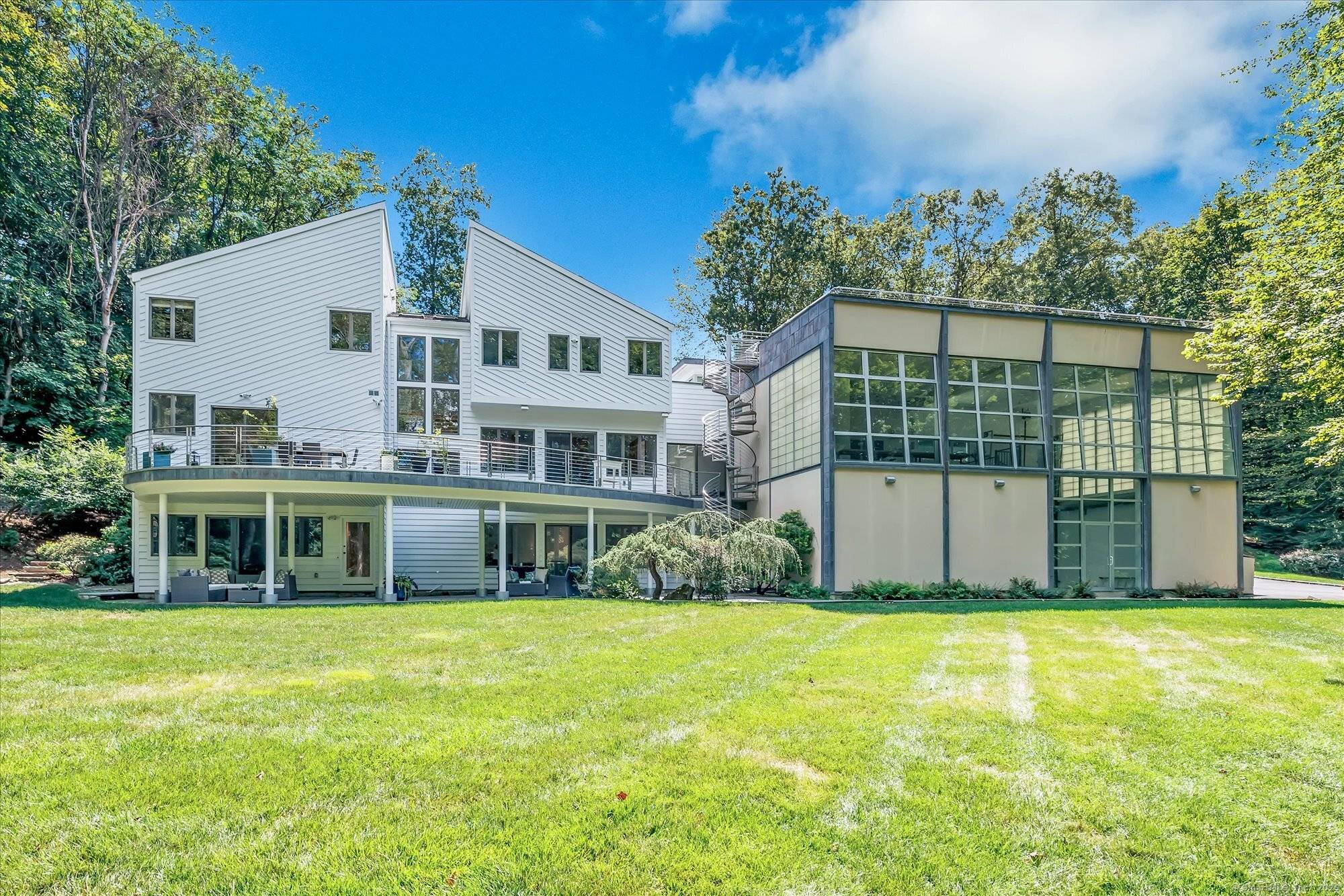 Tucked away on a private cul de sac just minutes from downtown Westport, beaches, and award winning restaurants, this 6 bedroom, 8 bath residence combines modern architectural design with serene ...