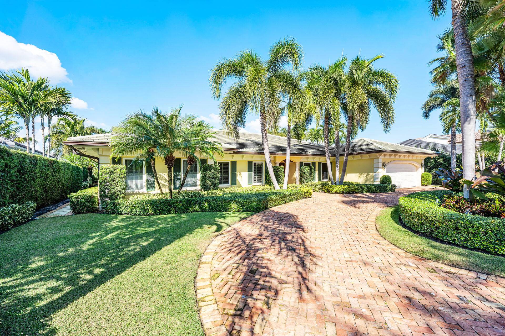 Set along the 3rd green of the Jack Nicklaus Signature Course, 1851 Thatch Palm Drive offers effortless single story living with a serene golf course backdrop.