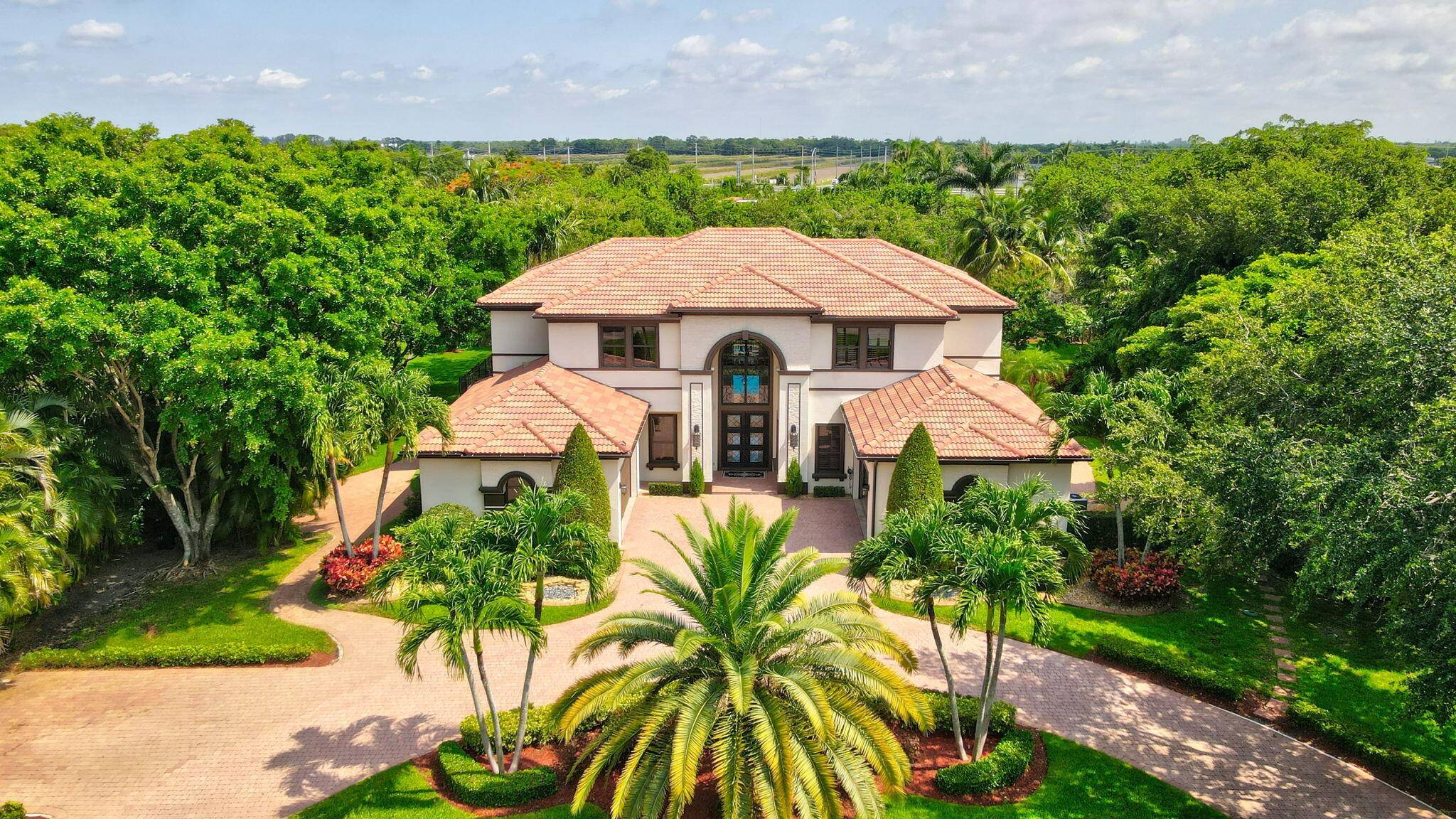 Tucked away on over an acre in one of Delray Beach's most exclusive gated enclaves, this custom built estate blends privacy, sophistication, and grand scale living.