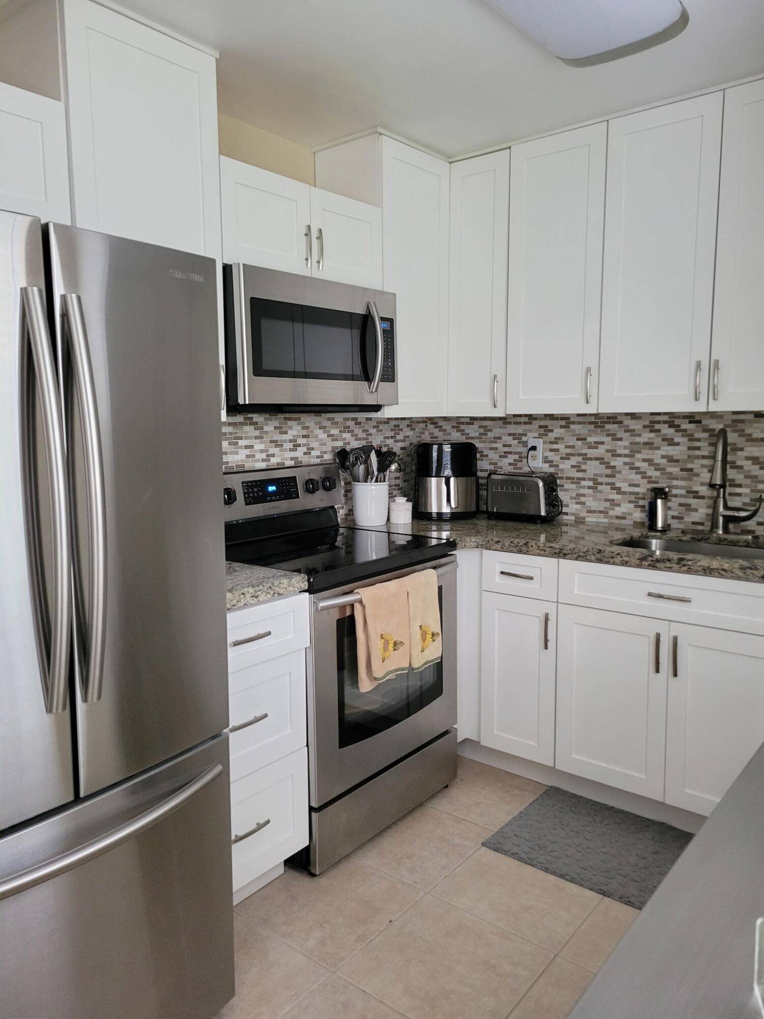 Beautifully Upgraded 2BD 2BA Enclosed Patio First Floor Unit in Kings Point 55 Community Luxury meets convenience in this stunning first floor garden view condo.