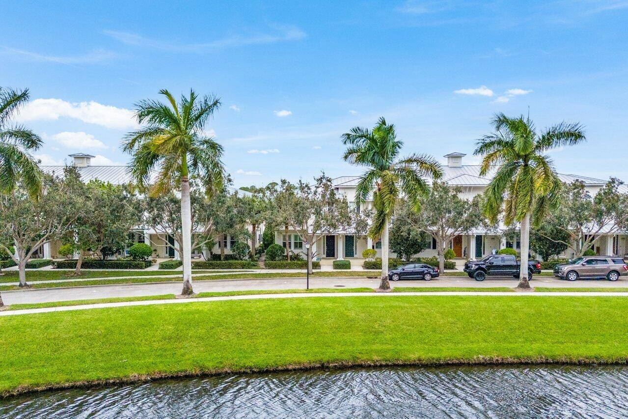 Lakefront Key West style end unit townhouse located in Abacoa's most desired neighborhood Mallory Creek.