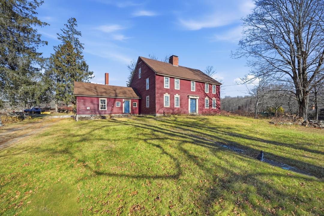 Step back in time with this enchanting New England Colonial set on a picturesque 3.