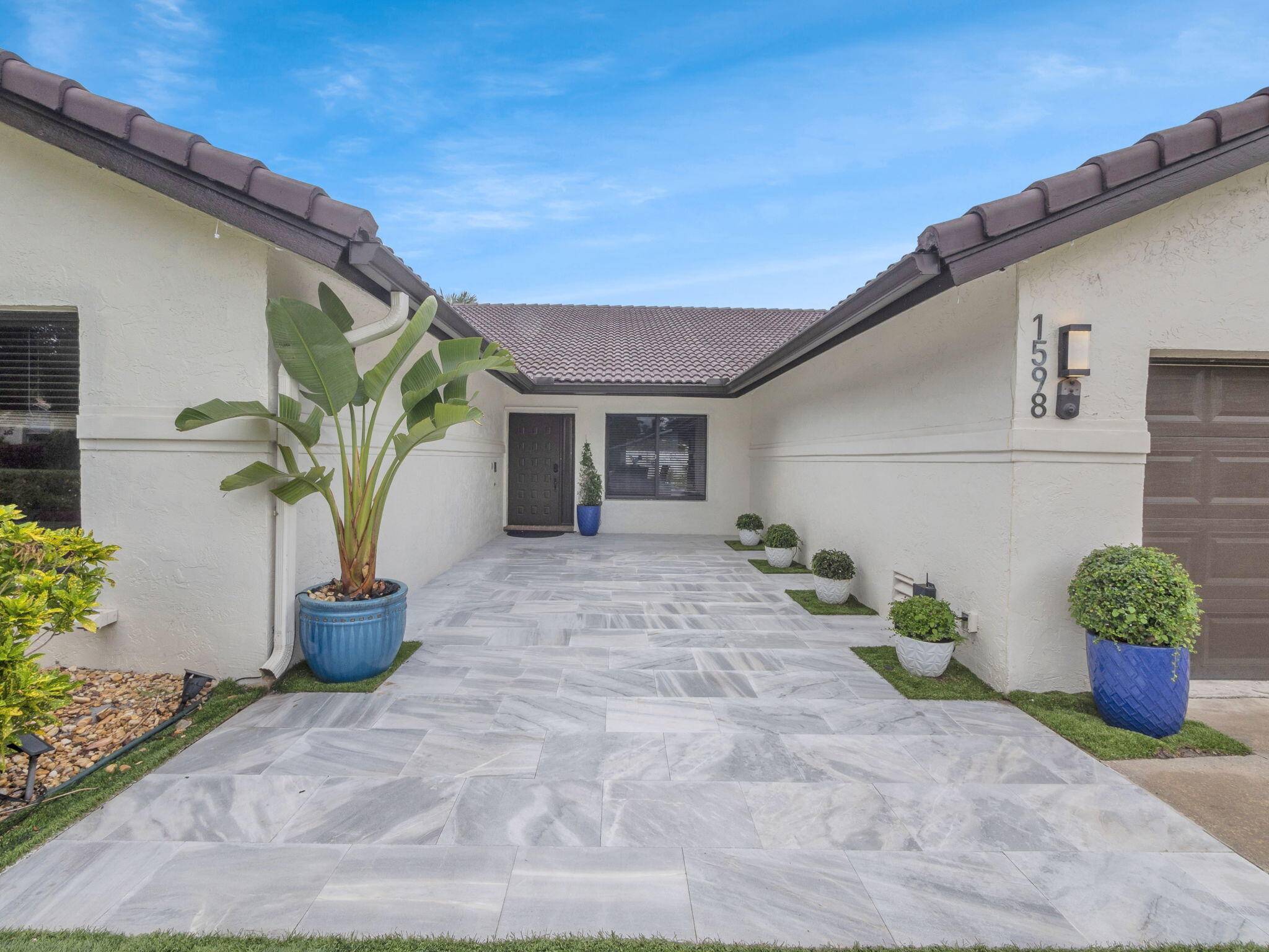 Magnificent 4BD 3BA corner lot home in the prestigious Palm Beach Farms, Boca Raton.