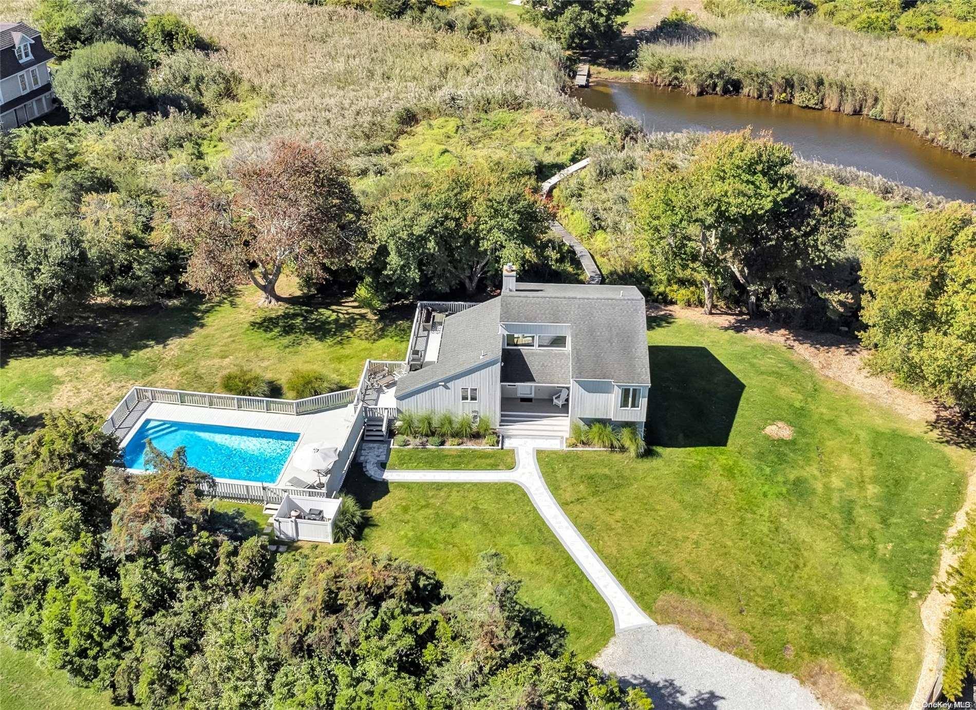 Situated in the quaint hamlet of Remsenburg on charming south of the highway Rogers Lane, this fully furnished home is privately nestled on a 1.