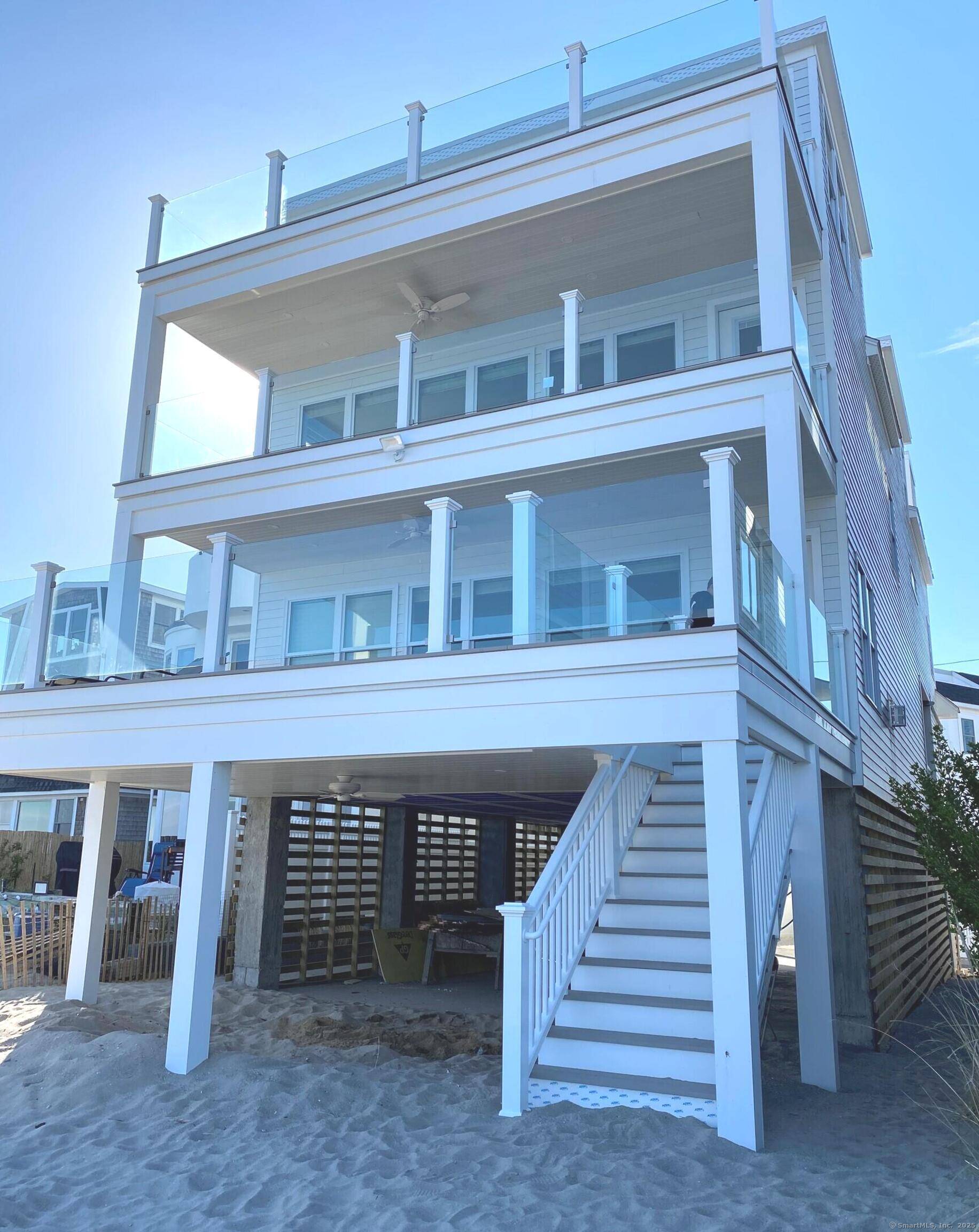 This updated 2021 beach house offers a tranquil escape on the Long Island Sound, providing direct beach access for immediate enjoyment of the waterfront.