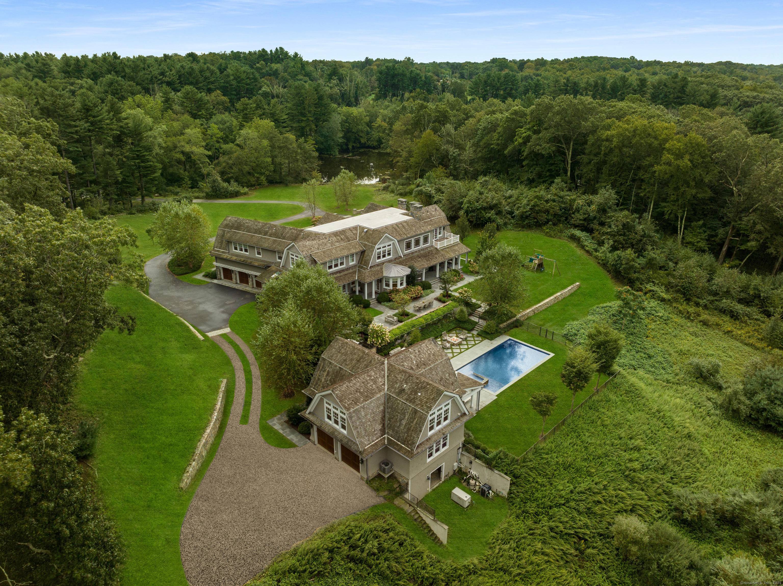 A rare offering, this Gambrel shingle style estate is a sanctuary on over 6 acres on a cul de sac, offering a secluded retreat.