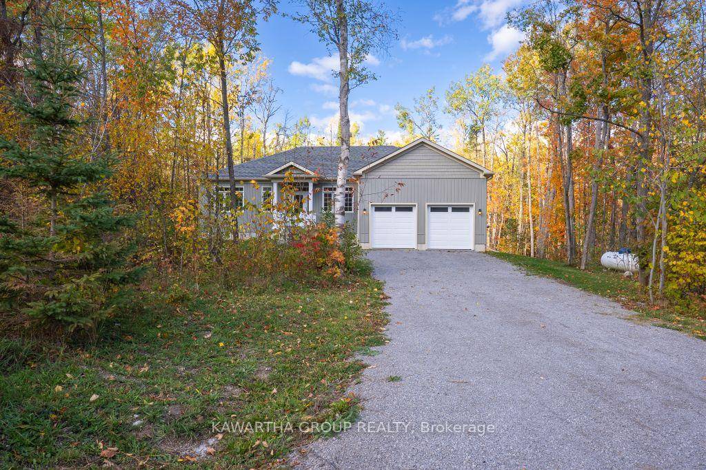 This custom built bungalow, completed in 2022 and covered by a Tarion warranty, sits on a scenic half acre lot surrounded by mature trees.
