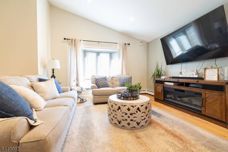 Raised ranch style home with unique sky top vaulted ceilings in the living room.