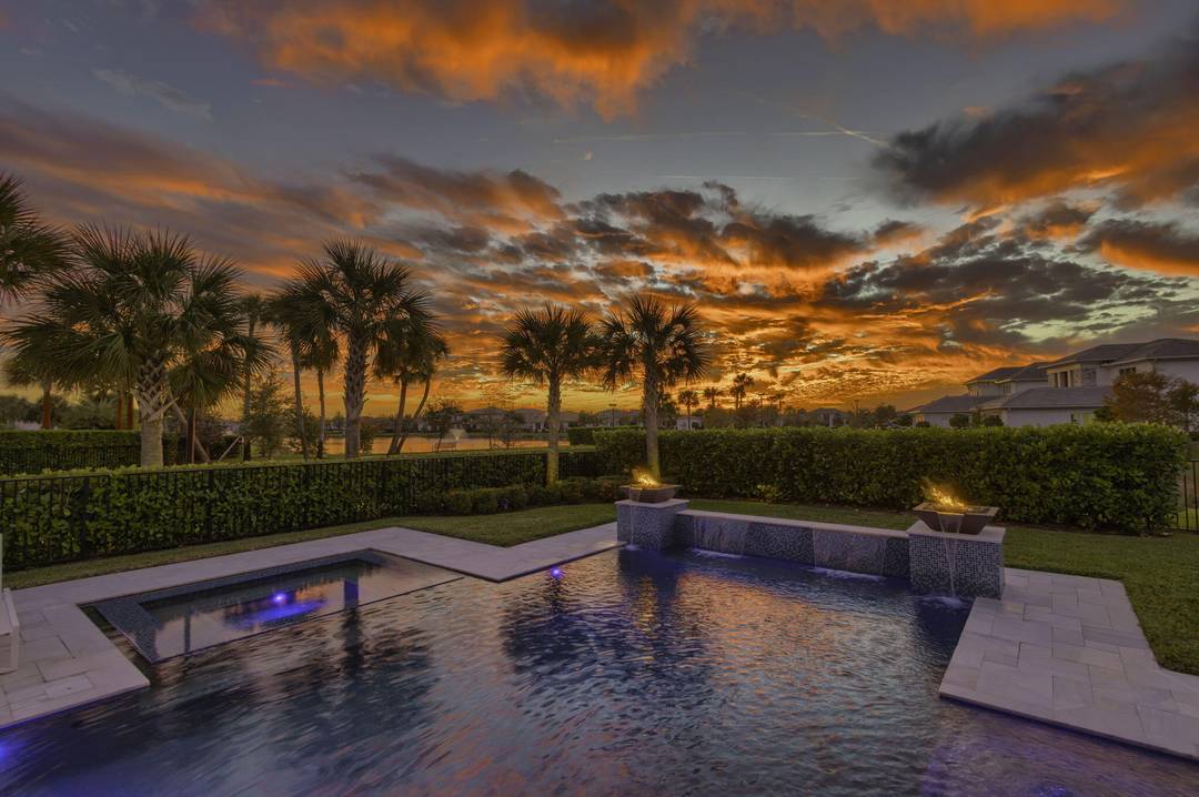 Stunning sunsets offering rare double water views overlooking serene lakes from this Luxury home.