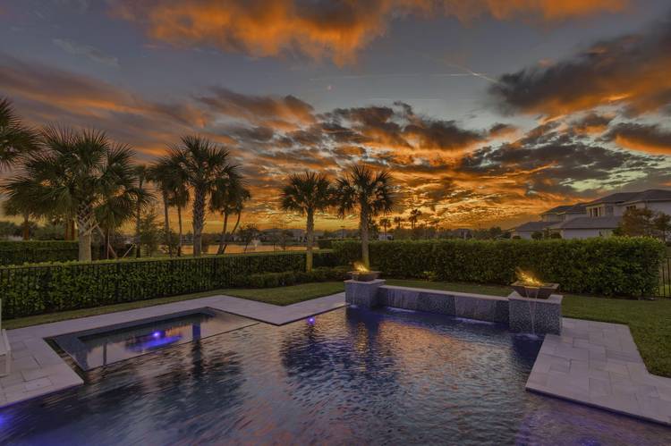 Stunning sunsets offering rare double water views overlooking serene lakes from this Luxury home.
