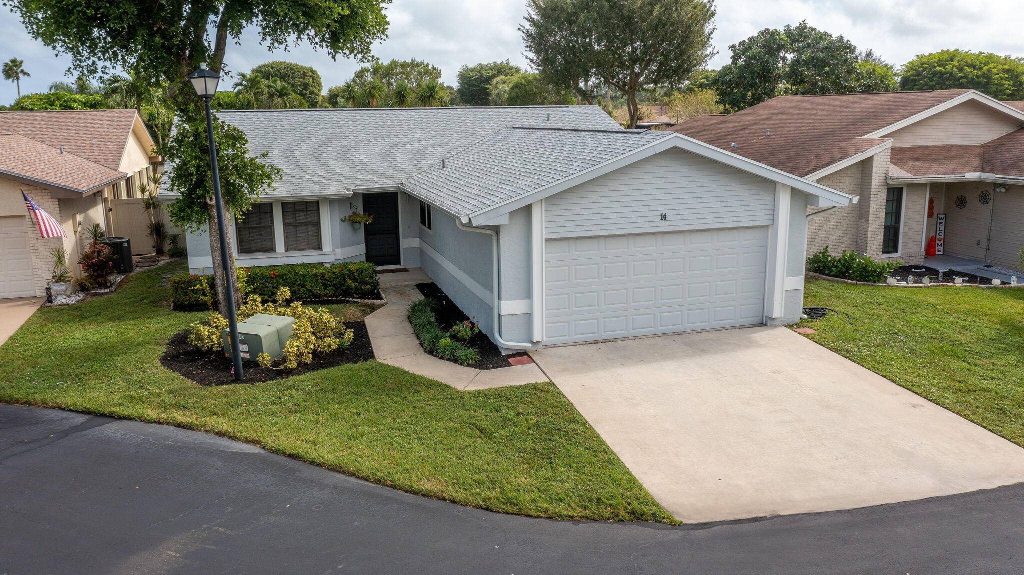 Charming 3BR 2BA home in Boynton Lakes with a new roof, 2 car garage, vaulted ceilings, updated kitchen, new bedroom carpet, and screened porch leading to a private fenced yard.