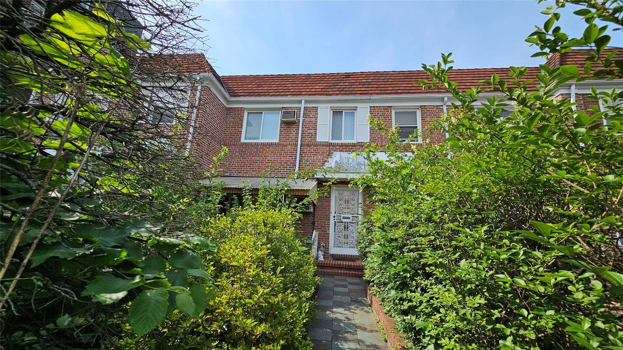 This solid brick attached home offers the perfect canvas to create your dream residence.