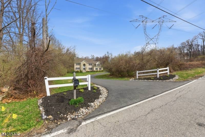 Elegant custom Colonial with partial stone front, set on a private 4.