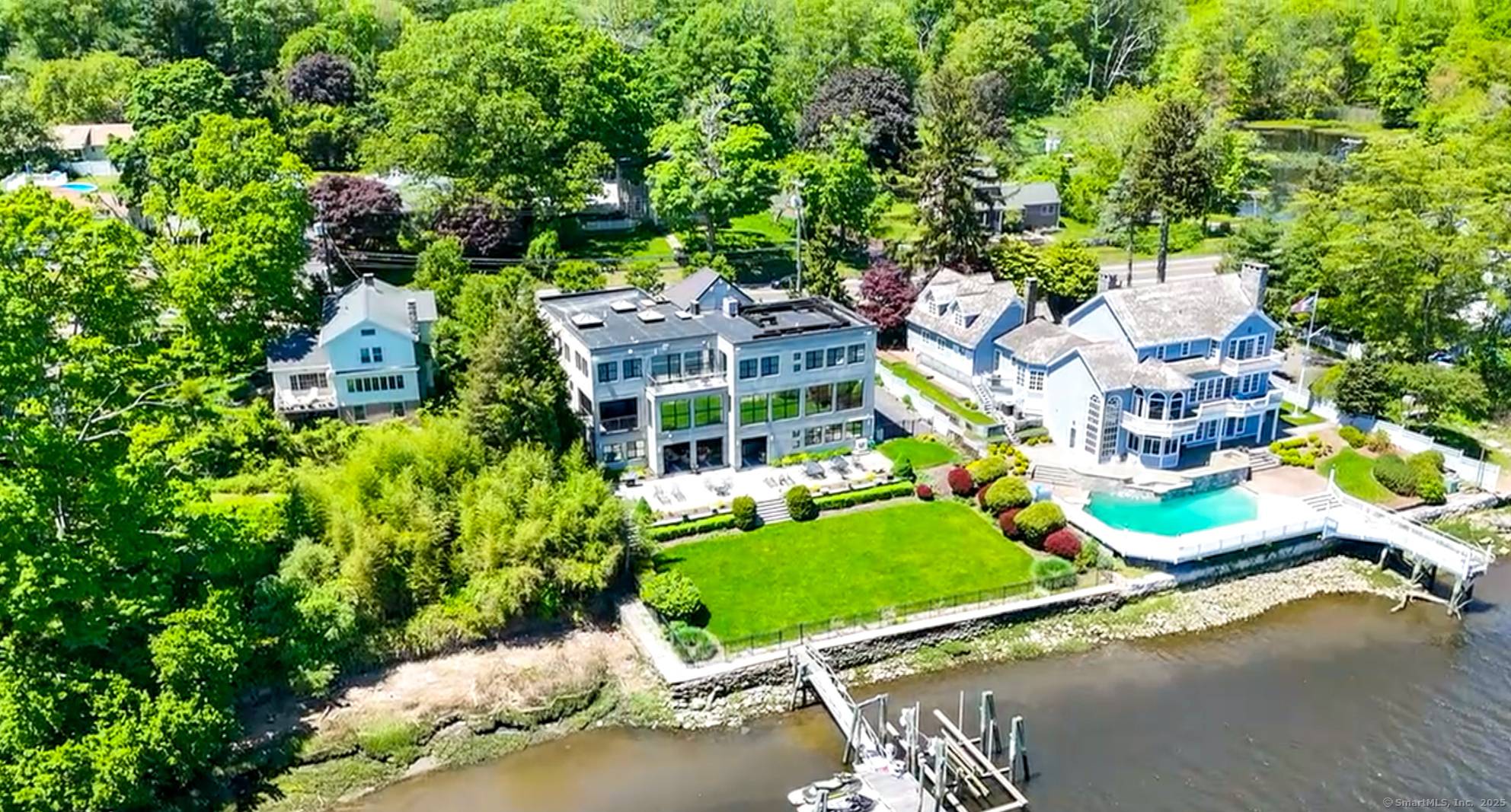 A rare, direct waterfront gem on the Housatonic River in Connecticut, this 7, 500 SF custom contemporary home offers modern luxury and scenic beauty.