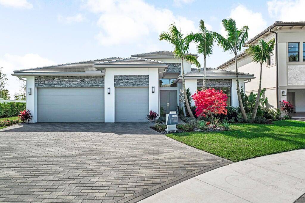 Discover the exceptional Adonis model, perfectly situated on Lot 66, offering breathtaking lake views within the prestigious Avenir community of Palm Beach Gardens.