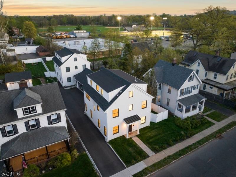Expertly designed by architect Tim Klesse, this stunning 2025 new construction offers sophisticated living space across four finished levels in the heart of Millburn.