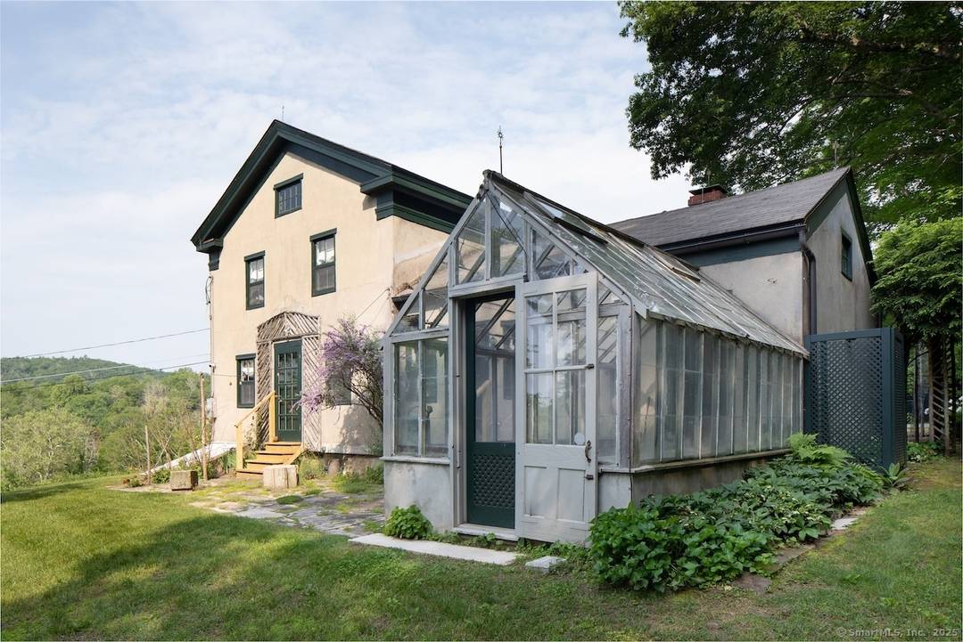 Set on a quiet road in Falls Village, Connecticut, this enchanting 1790s Irish inspired farmhouse offers magnificent western views to Falls Mountain and beyond.