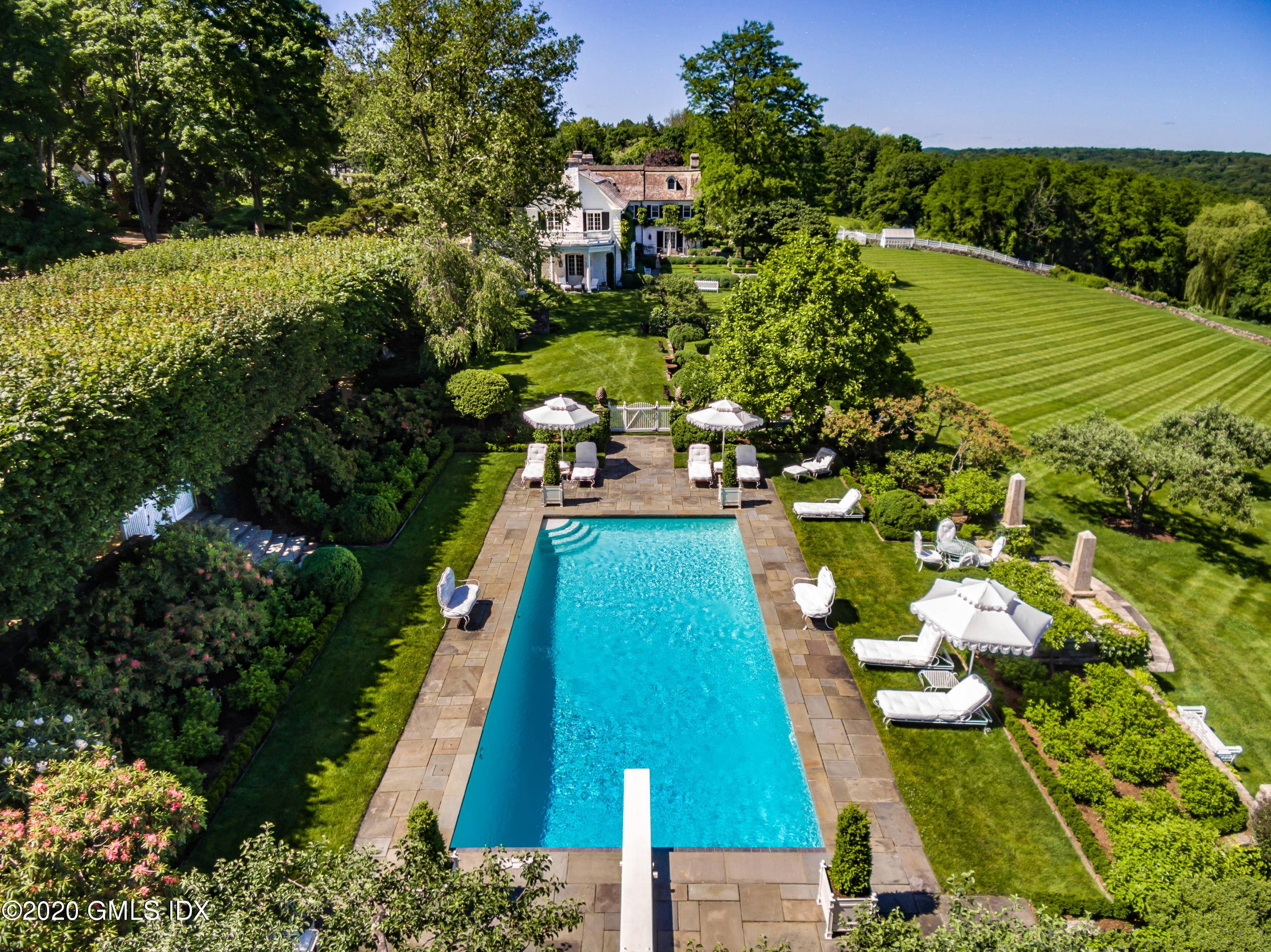 DENBIGH FARM Hilfiger's quintessential English country estate with breathtaking panoramic views of LI Sound sitting high above sea level.