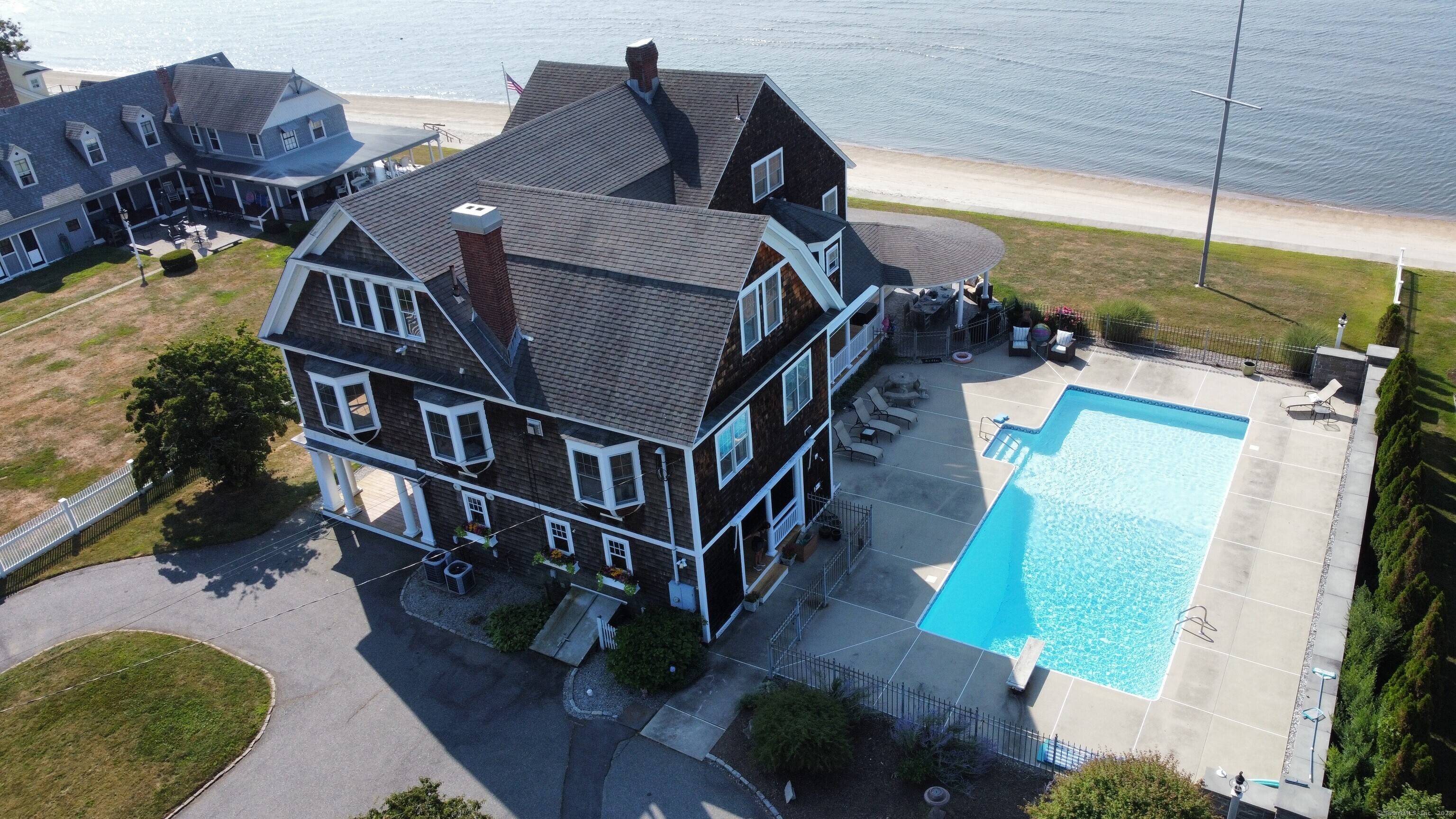 This stunning direct waterfront home offers 125 feet of sandy beach frontage on Long Island Sound and sits on 1.