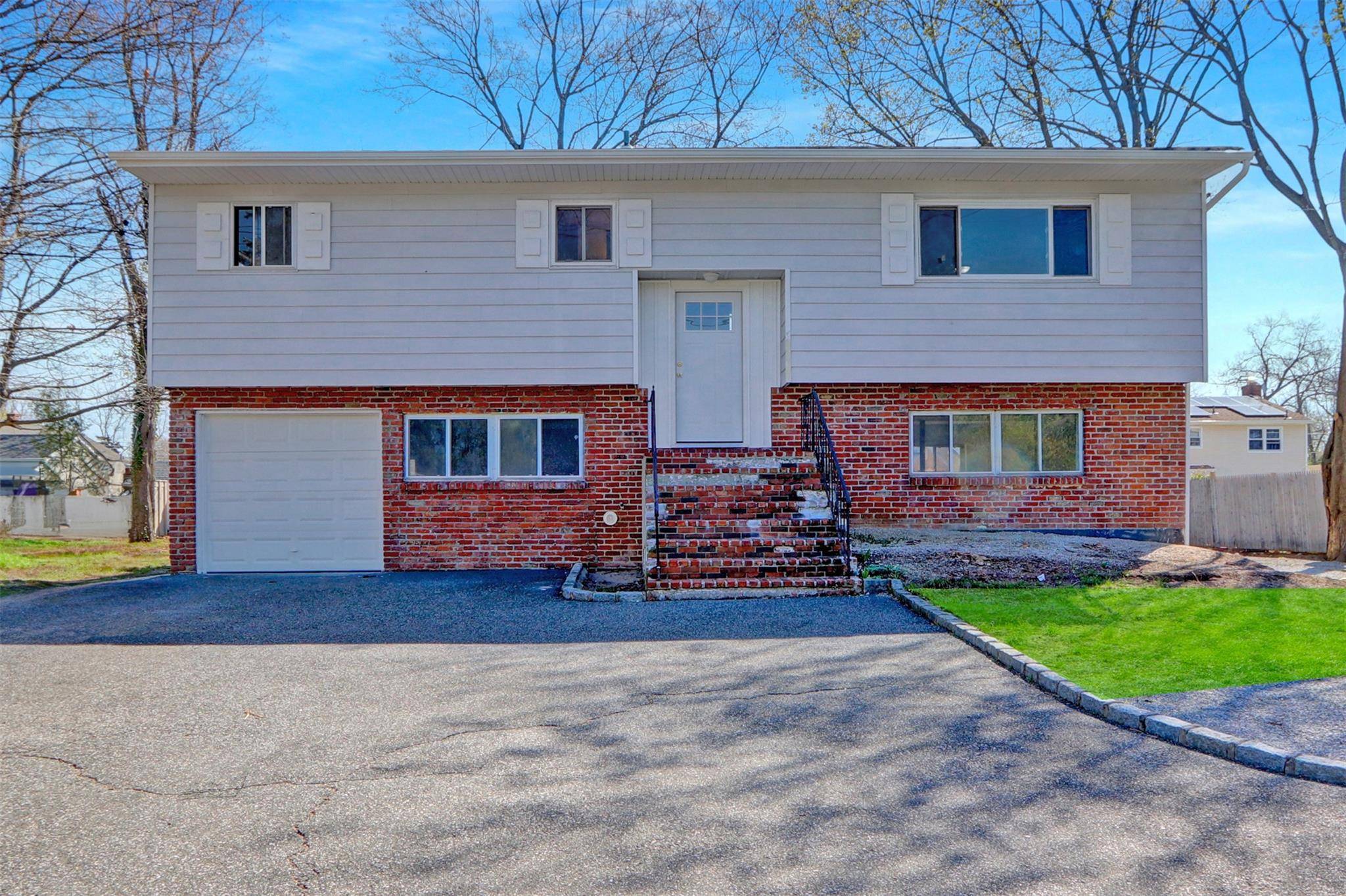 Great Hi Ranch style home with great location on dead end street, having a spacious layout, attached garage, large Eat in Kitchen, hardwood floors, and tremendous potential.