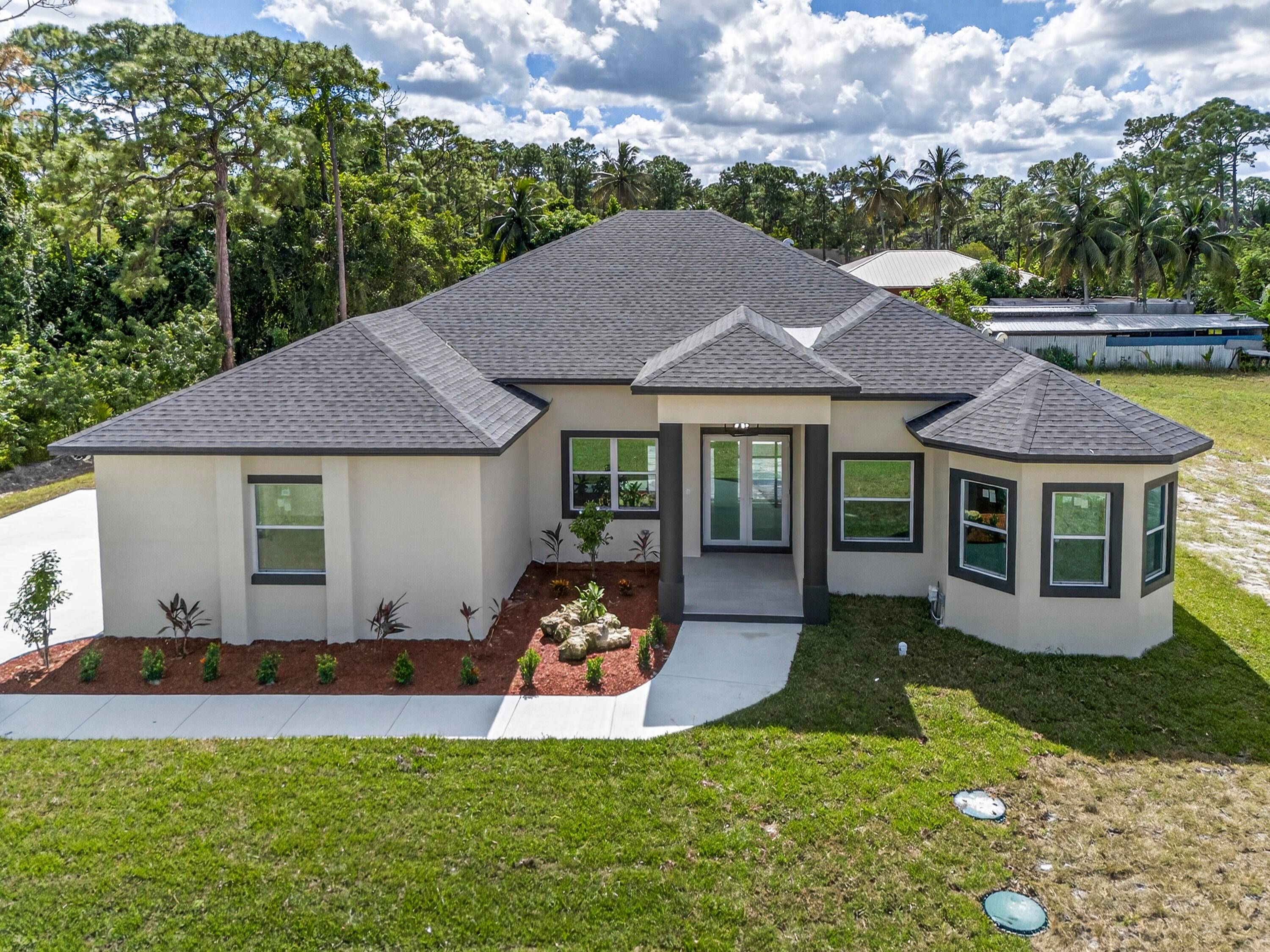 Welcome to 15174 69th Ct N, Loxahatchee, FL a stunning brand new construction home designed for modern living !