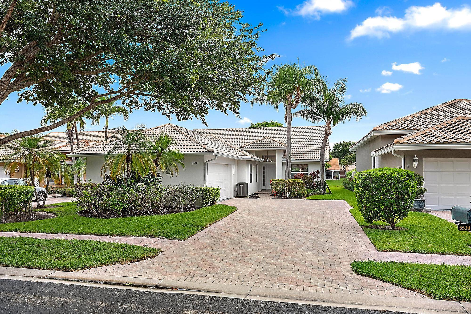 Enjoy the serene lake view of this fully remodeled home in the LOW HOA community of Palm Beach Bath Tennis.