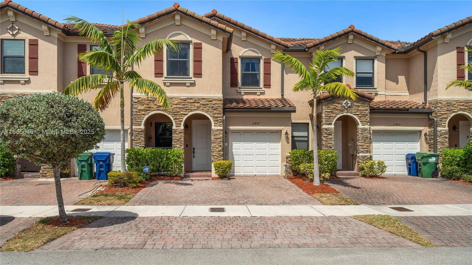 This contemporary townhome presents a large entry, airy dining room, eat in kitchen, and open concept family room complete with a custom wood beam.