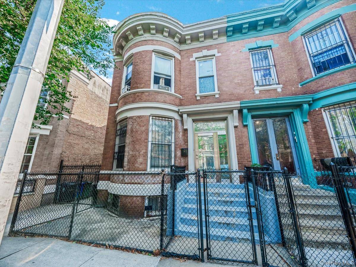 Classic and timeless barrel fronted brick semi detached two family on landmarked Manida Street in Hunts Point.