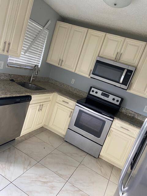 Beautifully renovated 3 bedroom, 2 bath villa end unit featuring a stunning new kitchen with white cabinets, granite countertops, and stainless steel appliances.