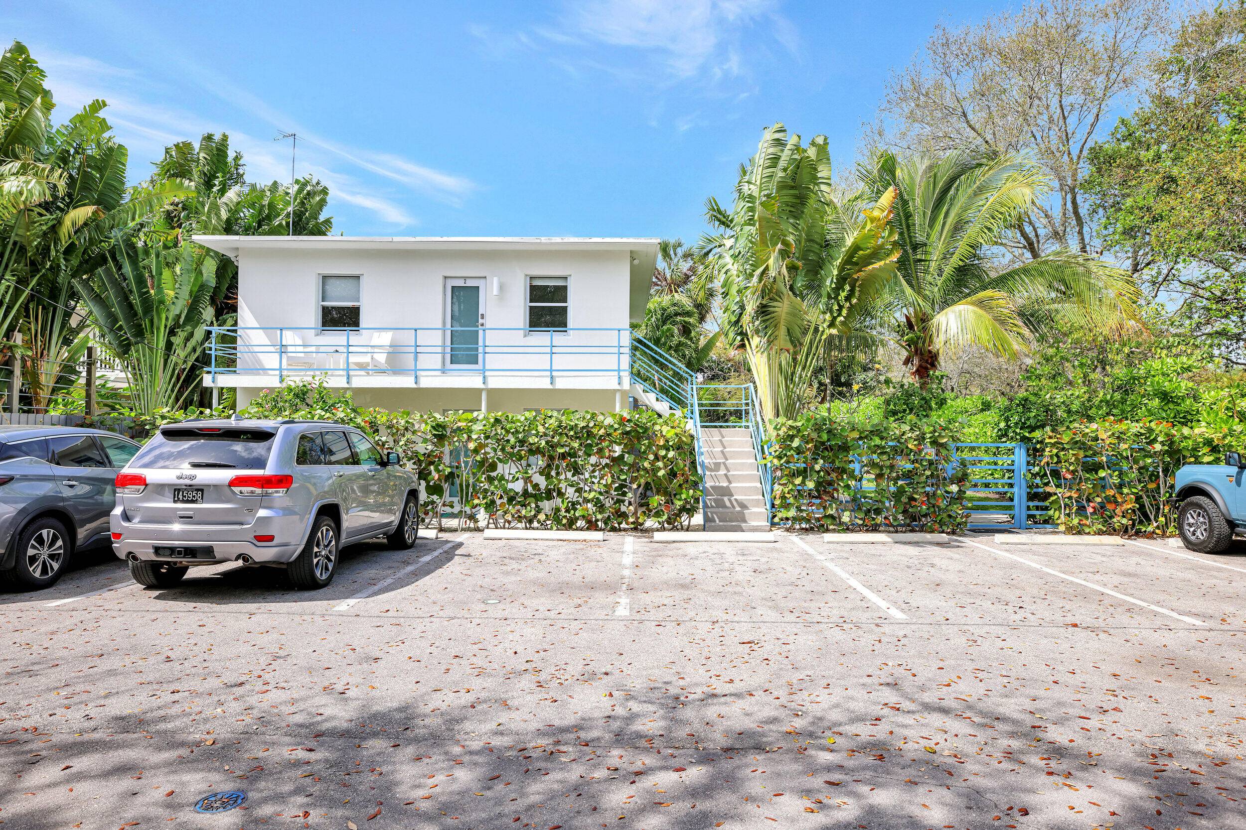 Discover a captivating Parkside Retreat a meticulously renovated Mid Century Fourplex, nestled within an expansive tropical oasis.