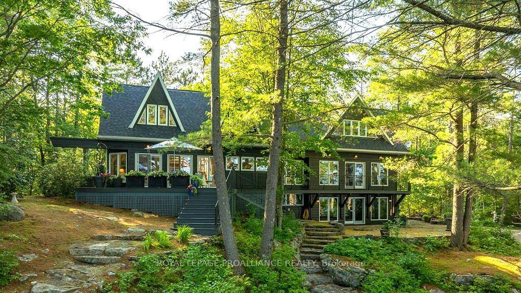 Immerse yourself in the tranquility and elegance of this architecturally inspired home, perfectly nestled into its natural surroundings on the pristine shores of Skootamatta Lake.