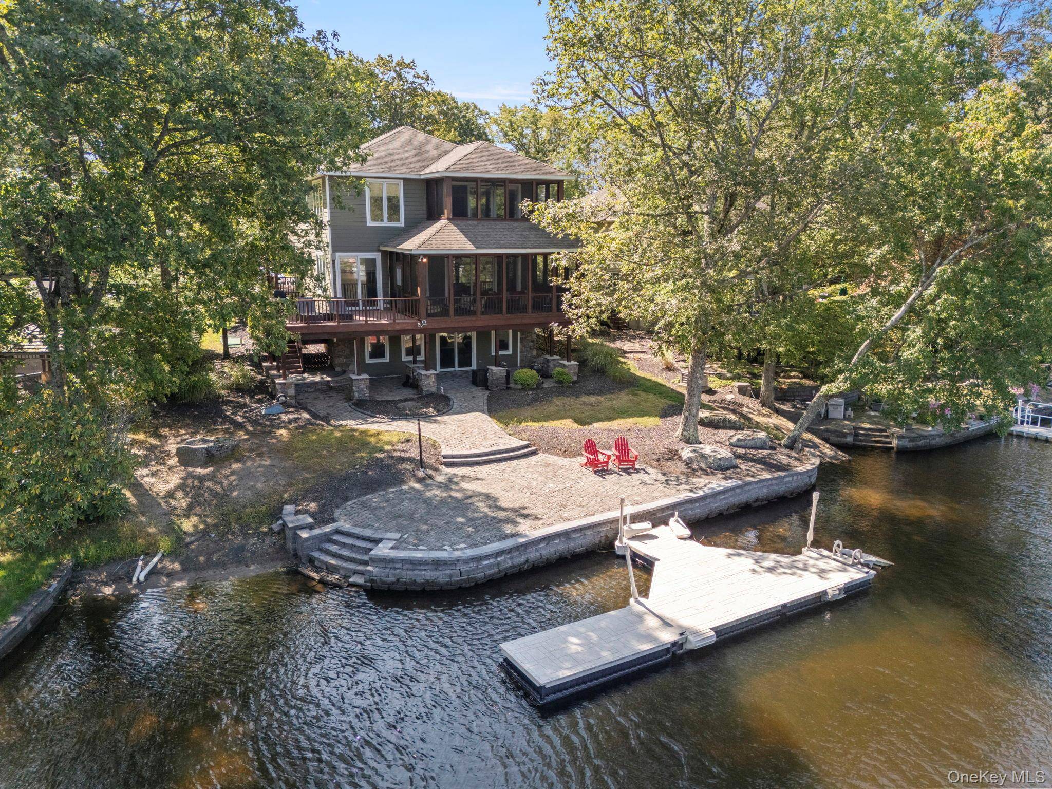 Custom Colonial in desirable Wanaksink Lake featuring open concept, chefs kitchen with large island, daycor stove, granite countertops and lots of custom cabinets, a dining area and gathering room with ...