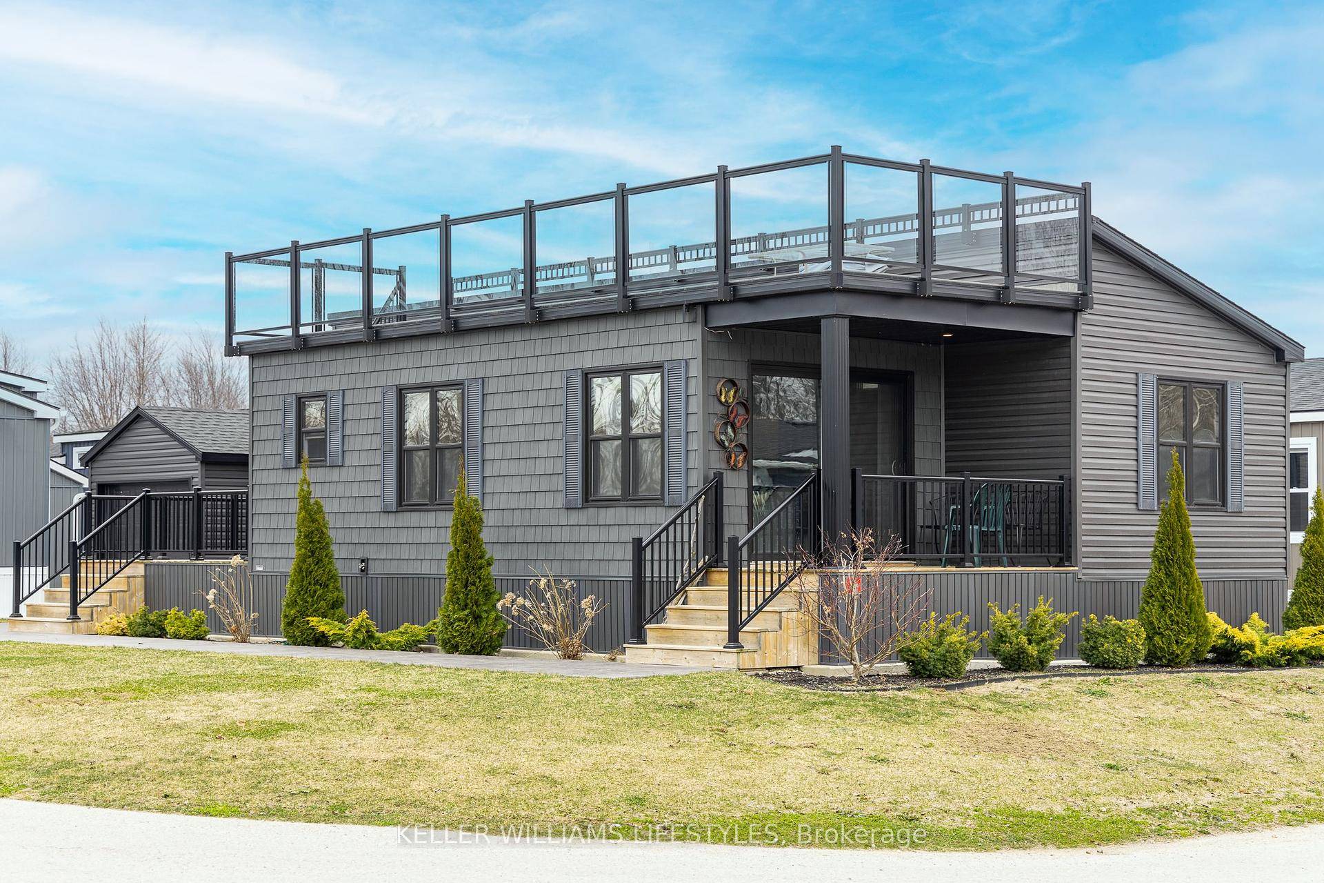 Welcome to Lot 61 in the picturesque Bluewater Shores Lakefront Resort in Bayfield, where modern comfort meets serene lakeside living.