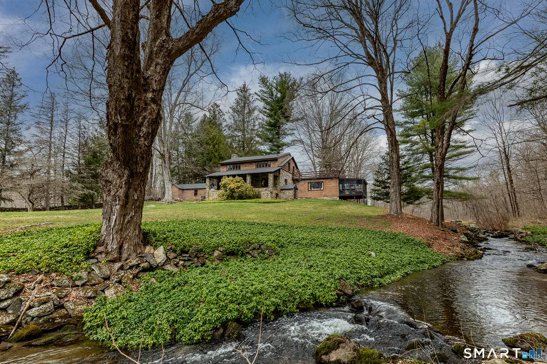 Over forty private wooded acres, a mountain stream, and hiking trails that lead to your own waterfall.