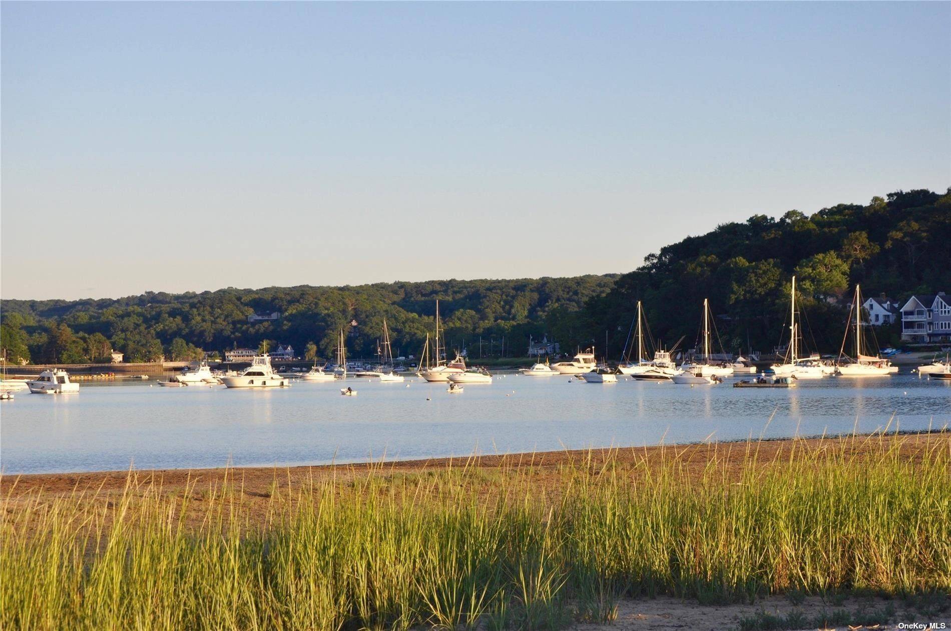 Over 1 acre of property in the Vanderbilt Section of Centerport with 53 feet of beach overlooking Centerport Harbor Northport Bay.