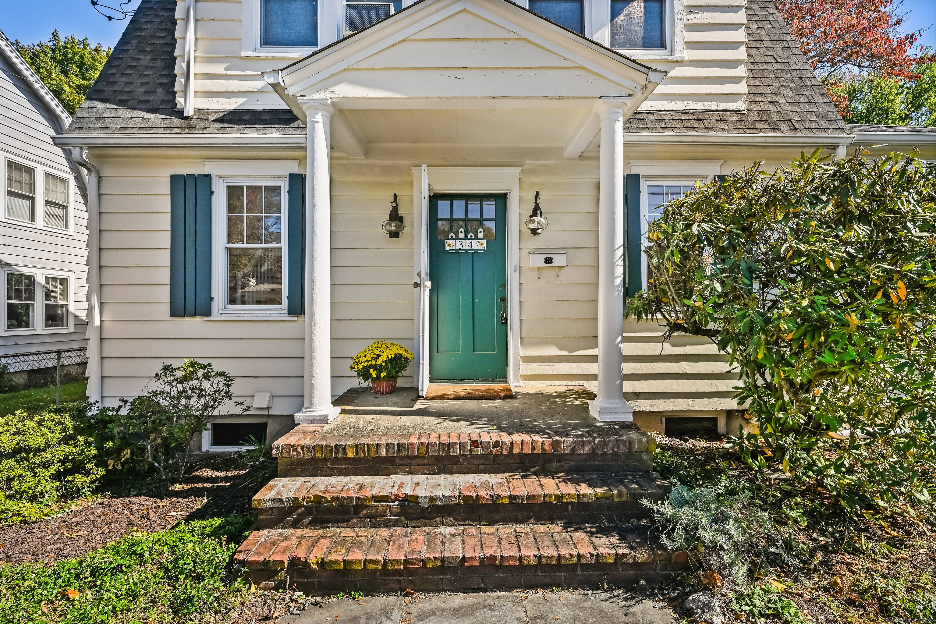 A classic 1920 Colonial home filled with character and charm of another era on a quiet street.