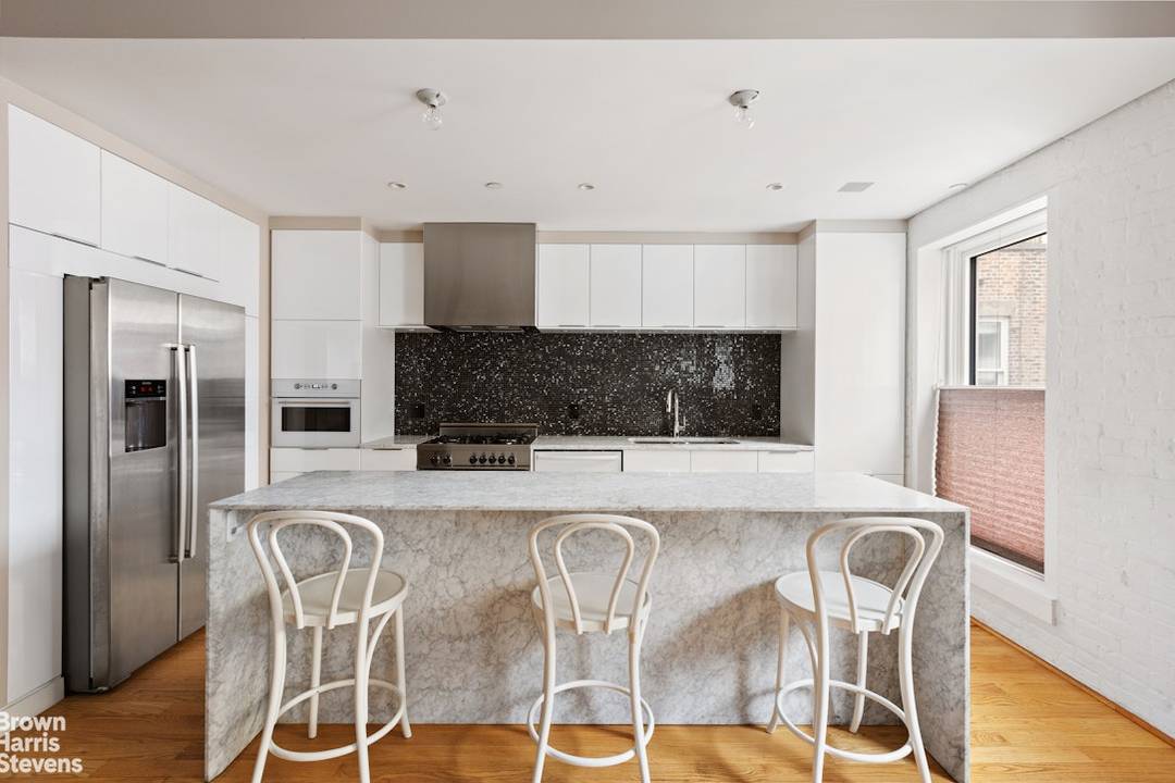 This meticulously renovated Tribeca loft seamlessly blends the iconic character of the neighborhood with contemporary luxury living.