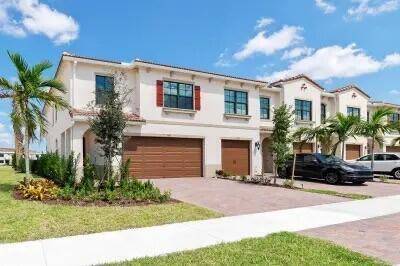 Beautiful two story lakefront townhome located in the gated community of Enclave at Boca Dunes.