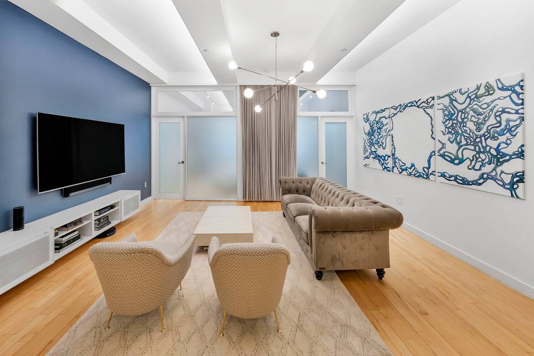 Welcome to Apartment 1824 at 15 Broad Street, an expansive loft residence thoughtfully redesigned to balance grand scale with exceptional functionality.