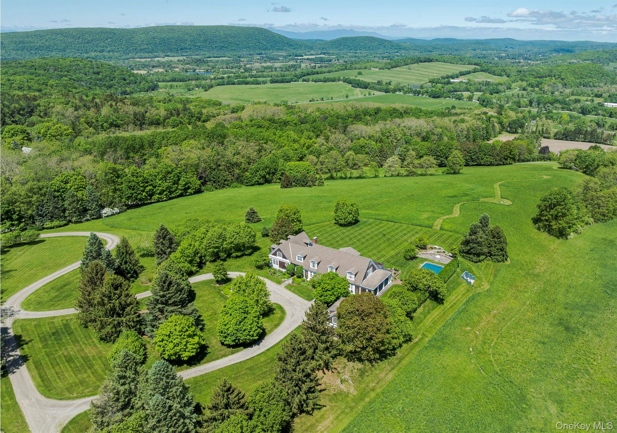 Nestled on top of Carpenter Hill, with unparalleled views of Stissing Mountain, the Catskills and the surrounding farmland, sits this country estate on 24.