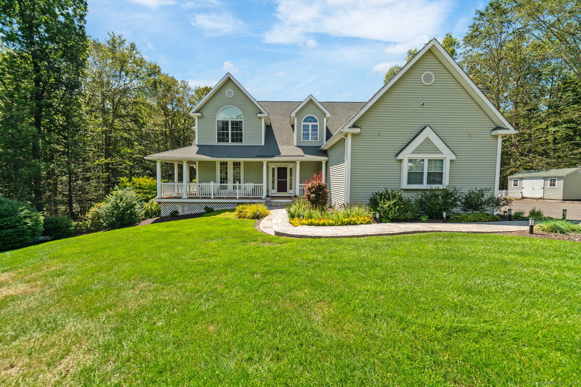 Exceptional custom built Colonial Farmhouse offering timeless charm privately nestled on.