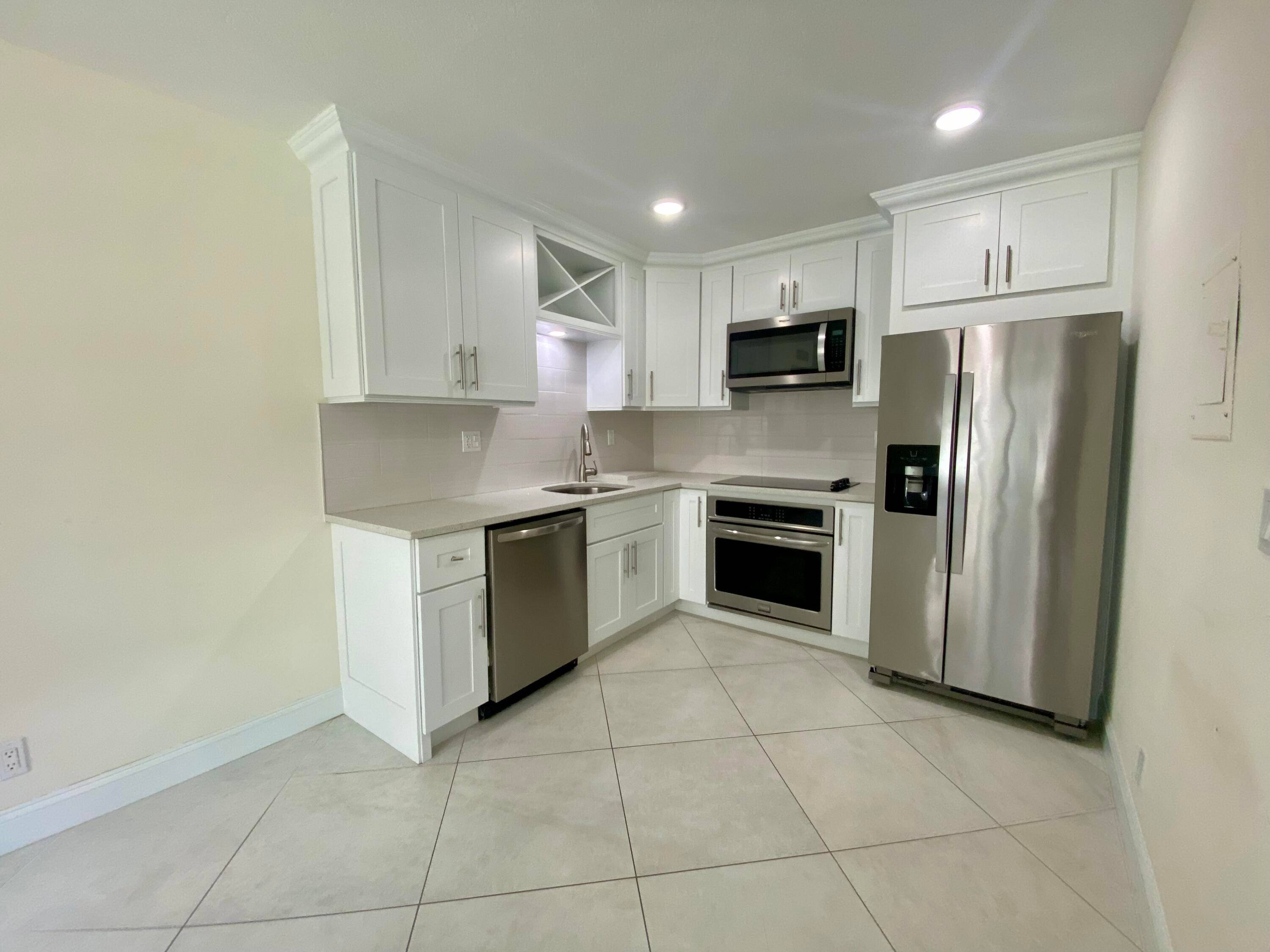 Gorgeous 1st floor 1 Bedroom completely renovated with tile floor throughout, recess lights, white cabinetry, quartz counter tops with stainless steel appliances.