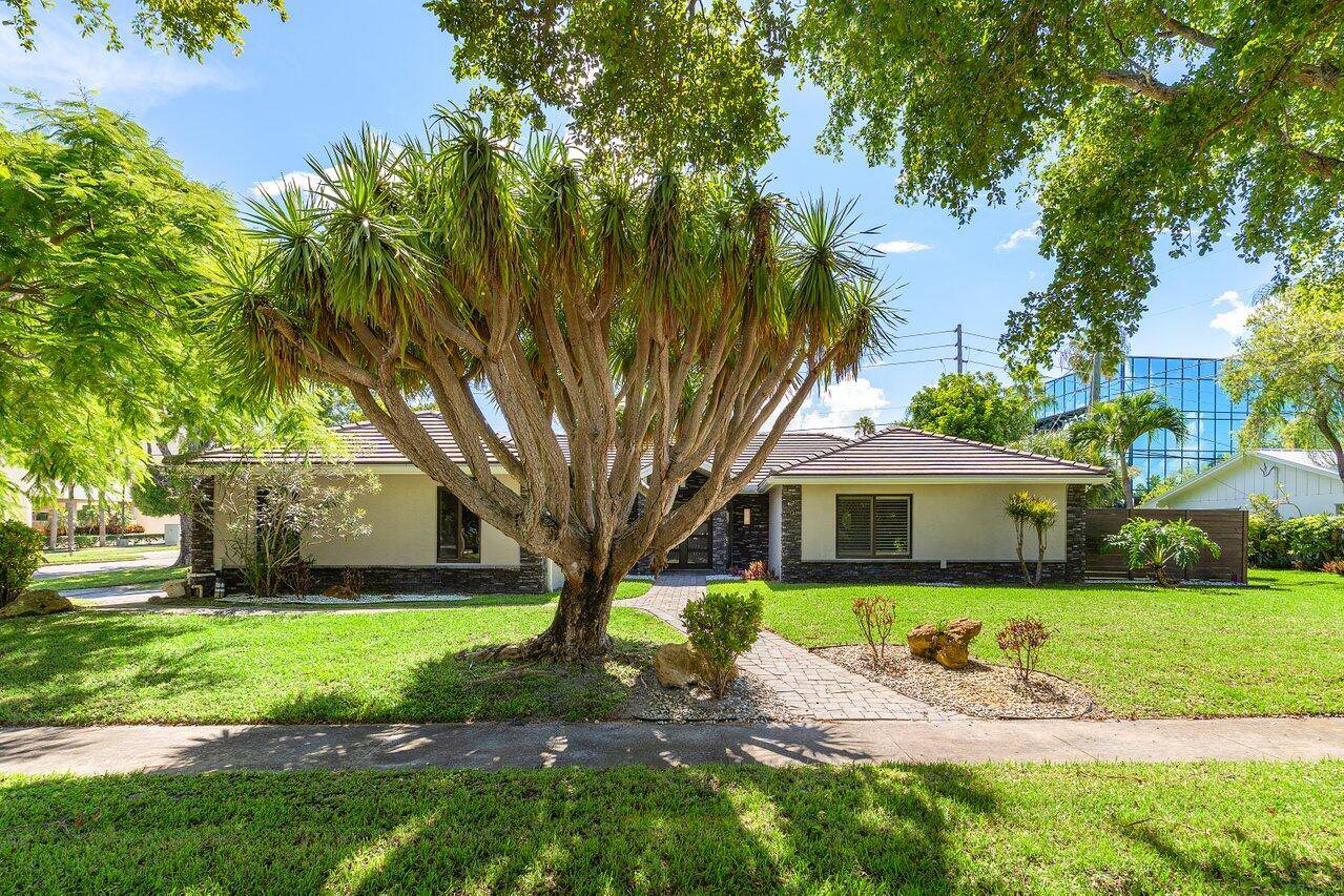 Extensively renovated home with redesigned exterior, added interior enclosure bath, pool remodel, pavers, new fence, faux finish garage door, tile floors, crown molding oversized baseboards.