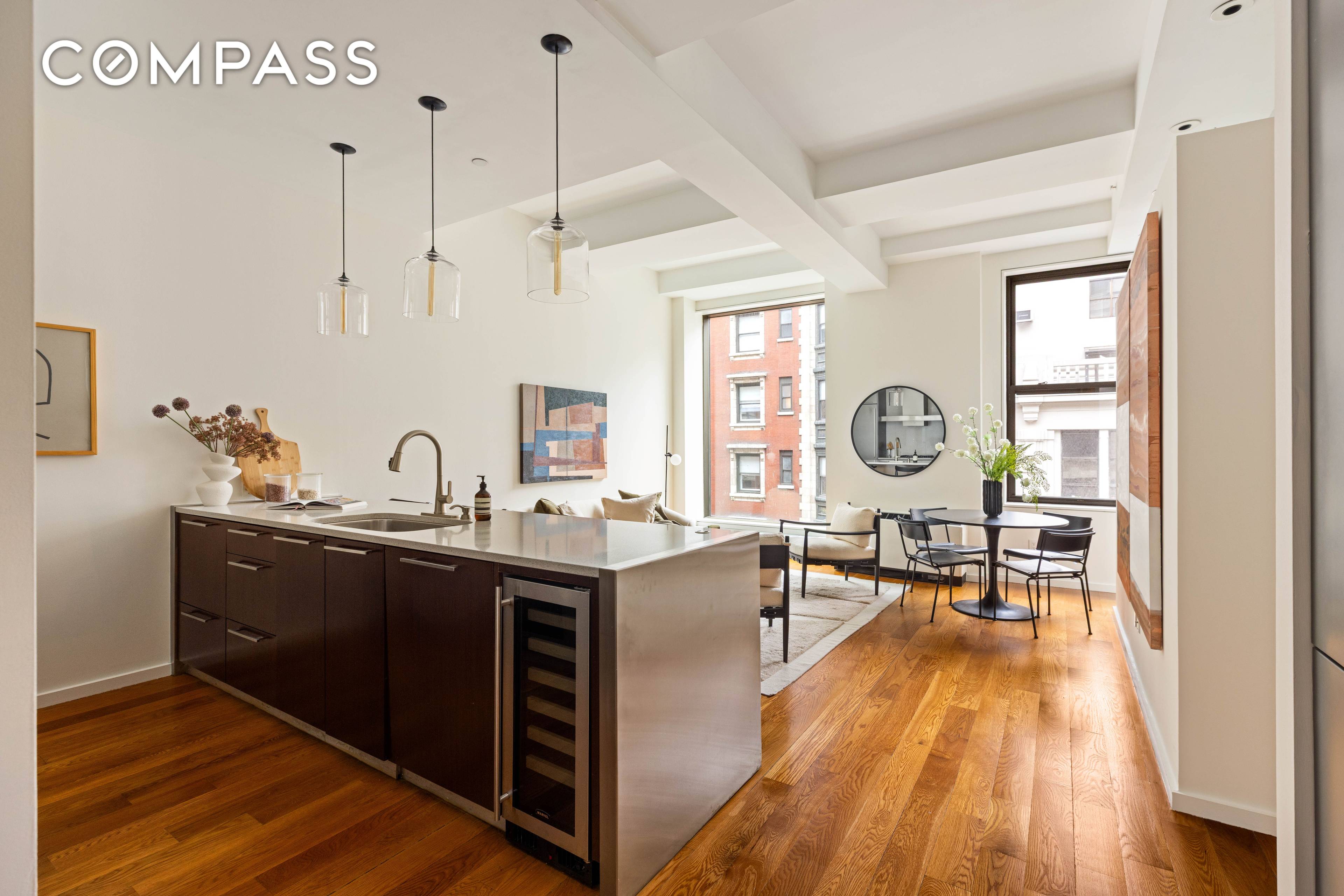 76 Madison Avenue, Unit 8C is a spacious 1 bedroom, 1 bath condominium in NoMad, featuring 11 high beamed ceilings and oversized windows offering skyline views.